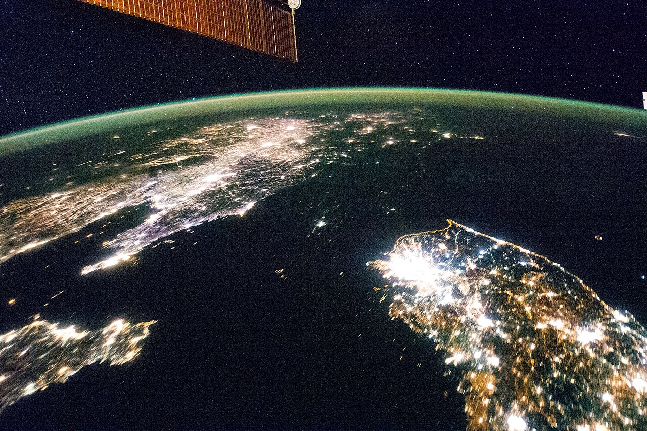 North and South Korea at night from the International Space Station, showing city lights across the peninsula.