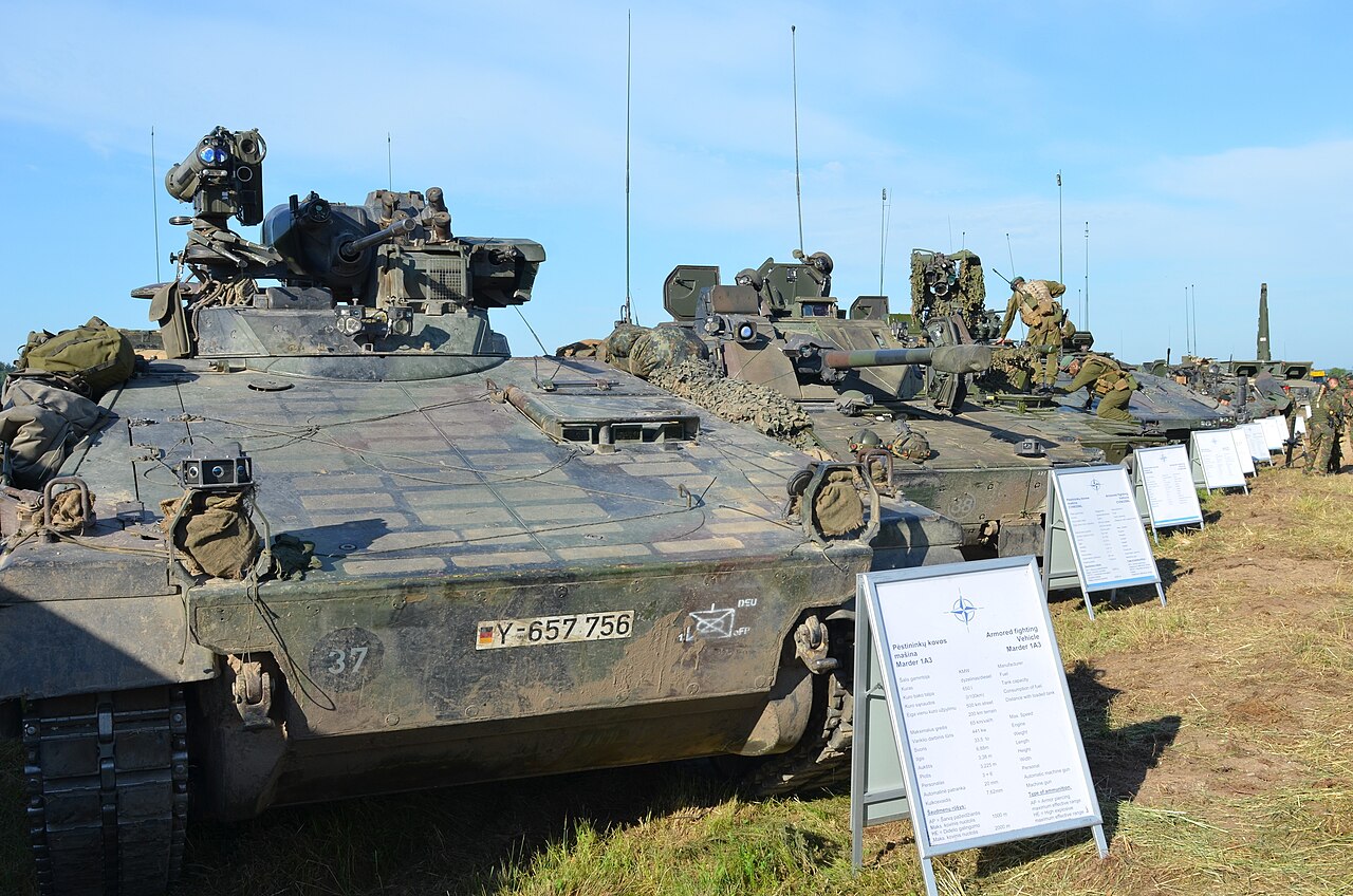 NATO military vehicles crossing the Suwalki Gap during combined exercises in Lithuania.