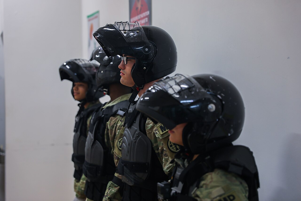 U.S. Army soldiers line up inside a U.S. Army Correctional Facility during a forced cell movement exercise.