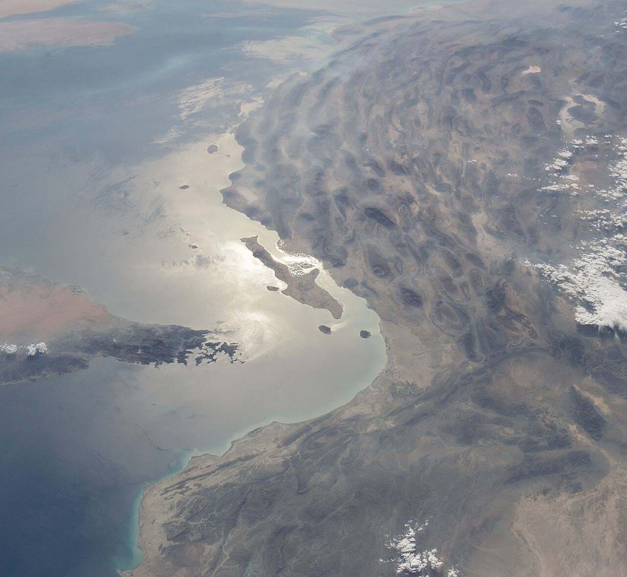 Contains modified NASA Earth Observatory imagery showing the Strait of Hormuz, Musandam Peninsula, Qeshm Island, and Persian Gulf region. File photo.