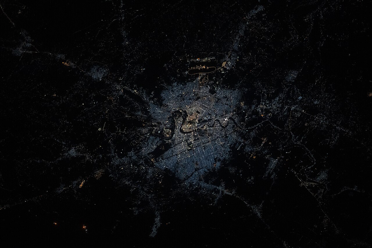 NASA imagery showing Baghdad split by the Tigris River with the airport visible.