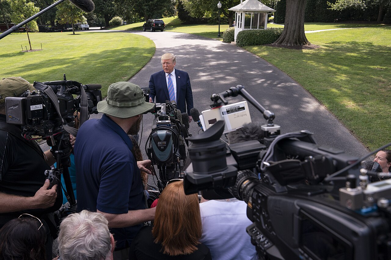 President Donald Trump speaks with reporters on the South Lawn of the White House.