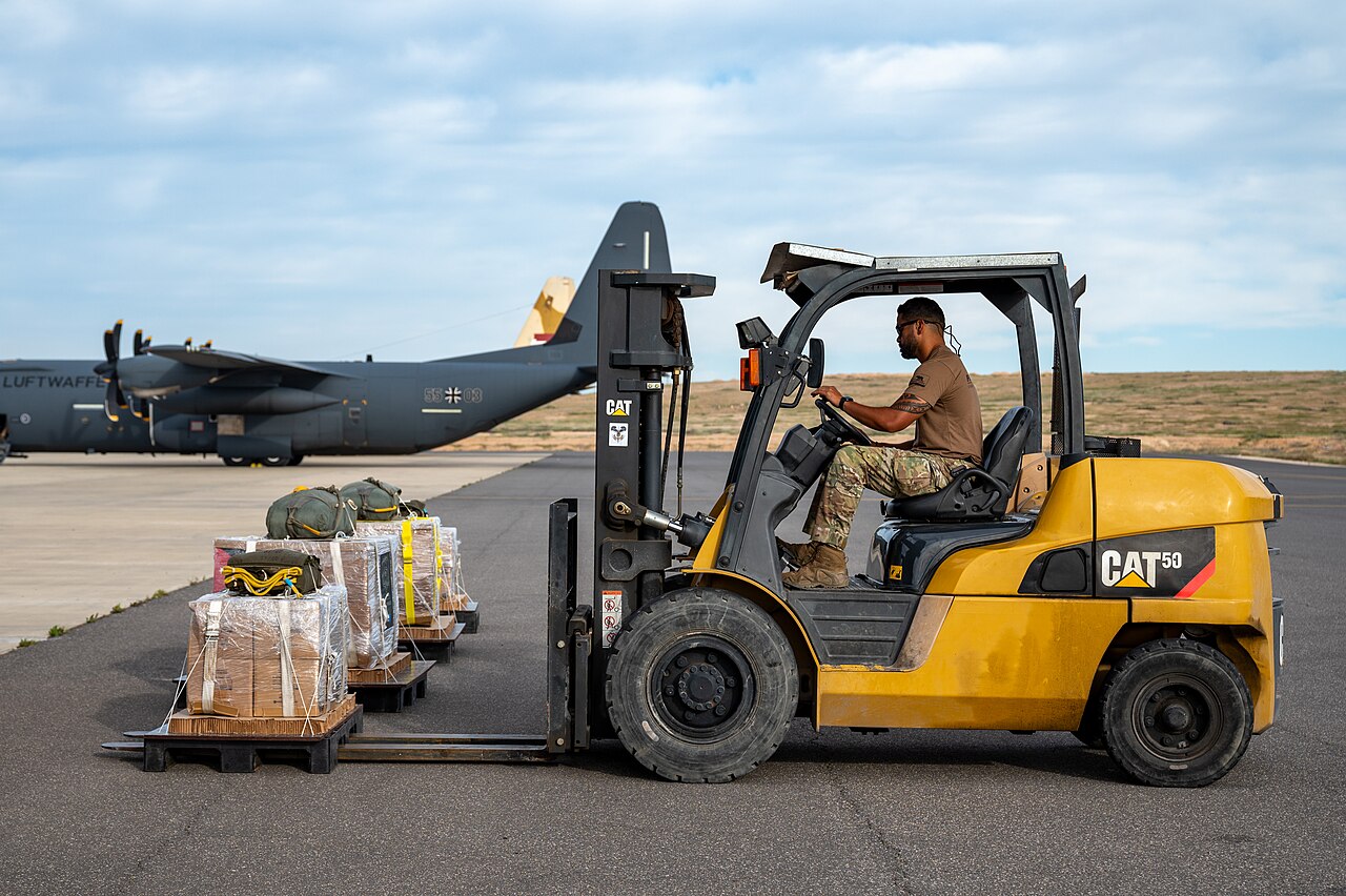 A U.S. Air Force pararescueman uses a forklift to transport bundles of Jordanian humanitarian aid onto a U.S. Air Force HC-130J Combat King II destined for an airdrop over Gaza, at an undisclosed location within the U.S. Central Command area of responsibility, March 16, 2024. File photo.