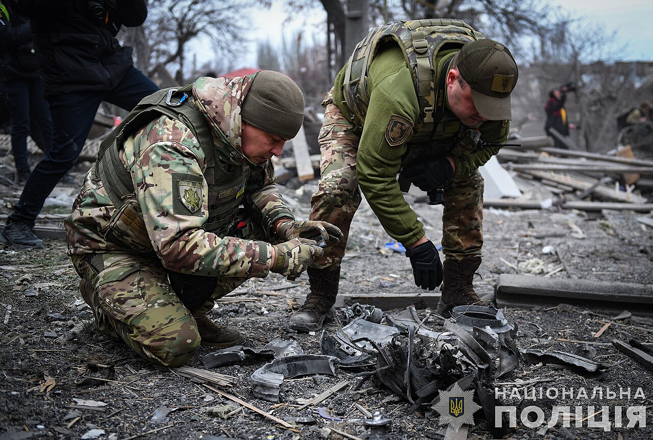 Destroyed buildings in Zaporizhzhia with police collecting missile remains after a Russian mass attack in December 2023.