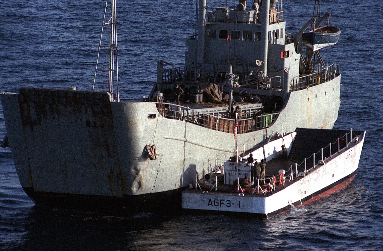 The captured Iranian mine-laying ship Iran Ajr with a U.S. Navy landing craft alongside.