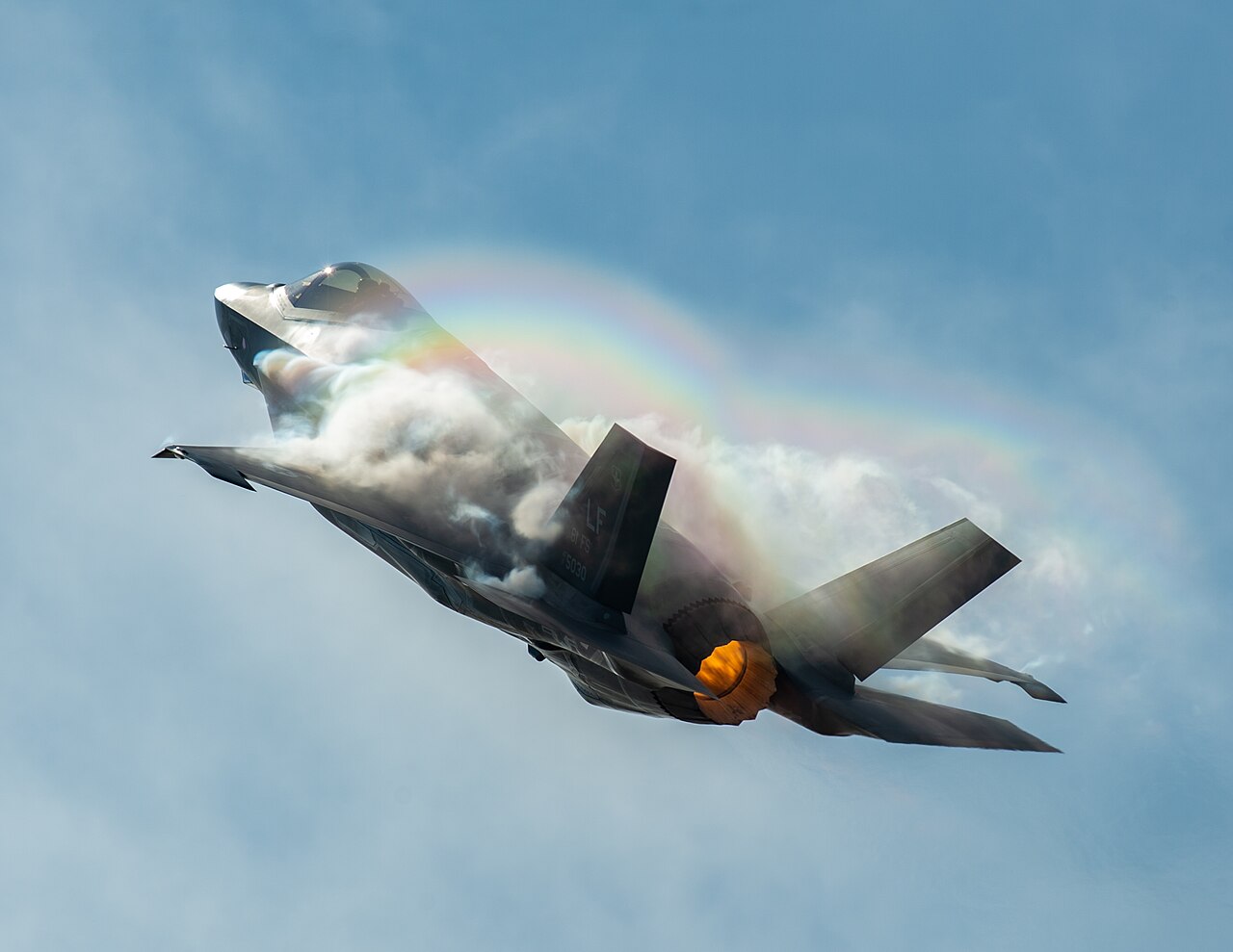 An F-35A Lightning II performs a vertical climb during an air show.